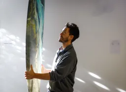 Patricio Guerrero, CEO of Swellcycle, holds an Artboard which is a custom designed board that can have a picture or brand printed on, at Swellcycle headquarters in Santa Cruz, Calif., on Wednesday, Oct. 29, 2025. (Shae Hammond/Bay Area News Group)