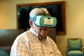 Jim Holtshouse watches video through a Rendever virtual-reality headset at the Forum at Rancho San Antonio retirement community in Cupertino, Calif. on June 11, 2025. (AP Photo/Terry Chea)
