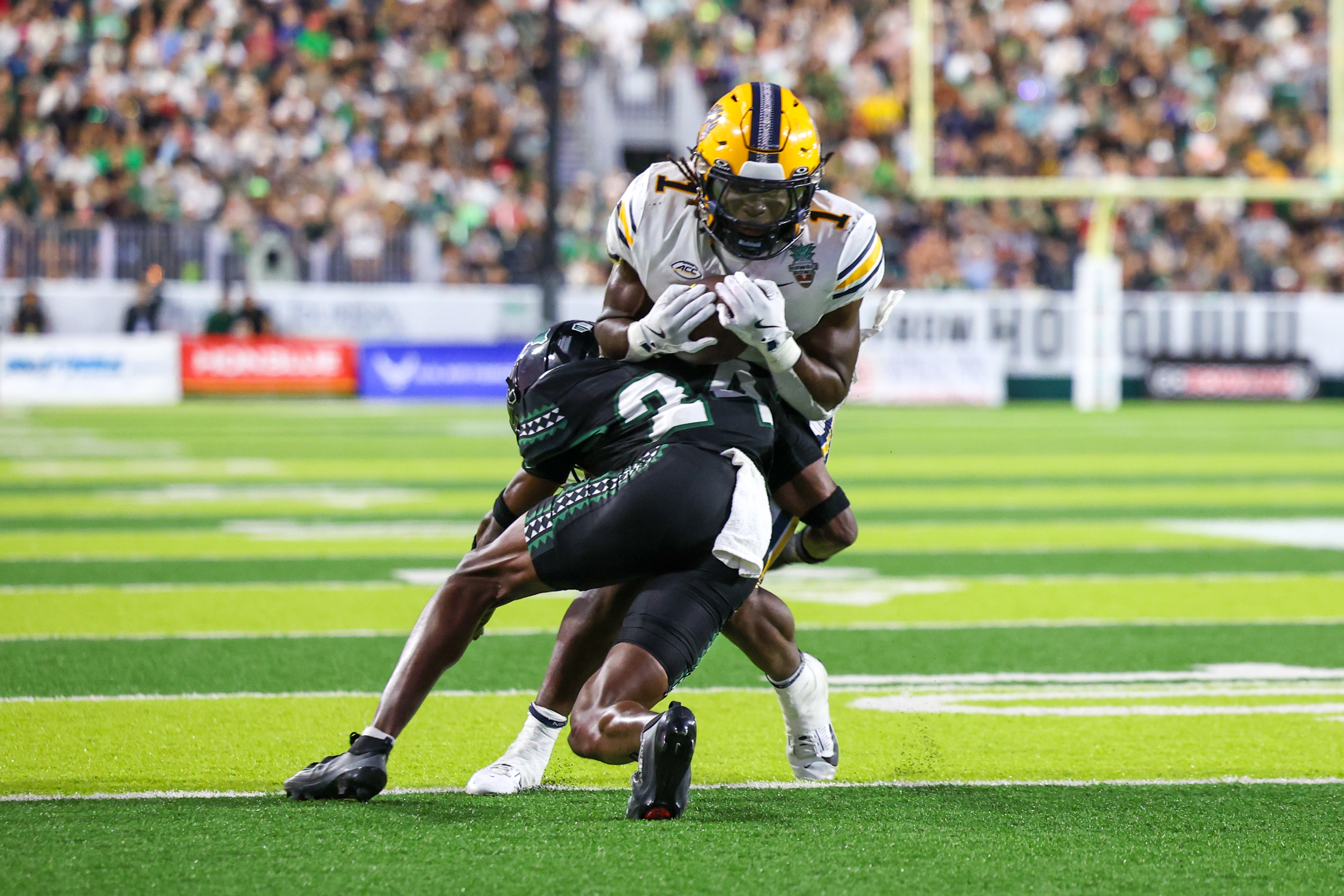 HONOLULU, Hawai'i - DECEMBER 24: Kendrick Raphael #1 of the California Golden Bears is tackled by Devyn King #24 of the Hawai'i Rainbow Warriors during the second half of the Sheraton Hawai'i Bowl at the Clarence T.C. Ching Athletics Complex on December 24, 2025 in Honolulu, Hawai'i. (Photo by Darryl Oumi/Getty Images)