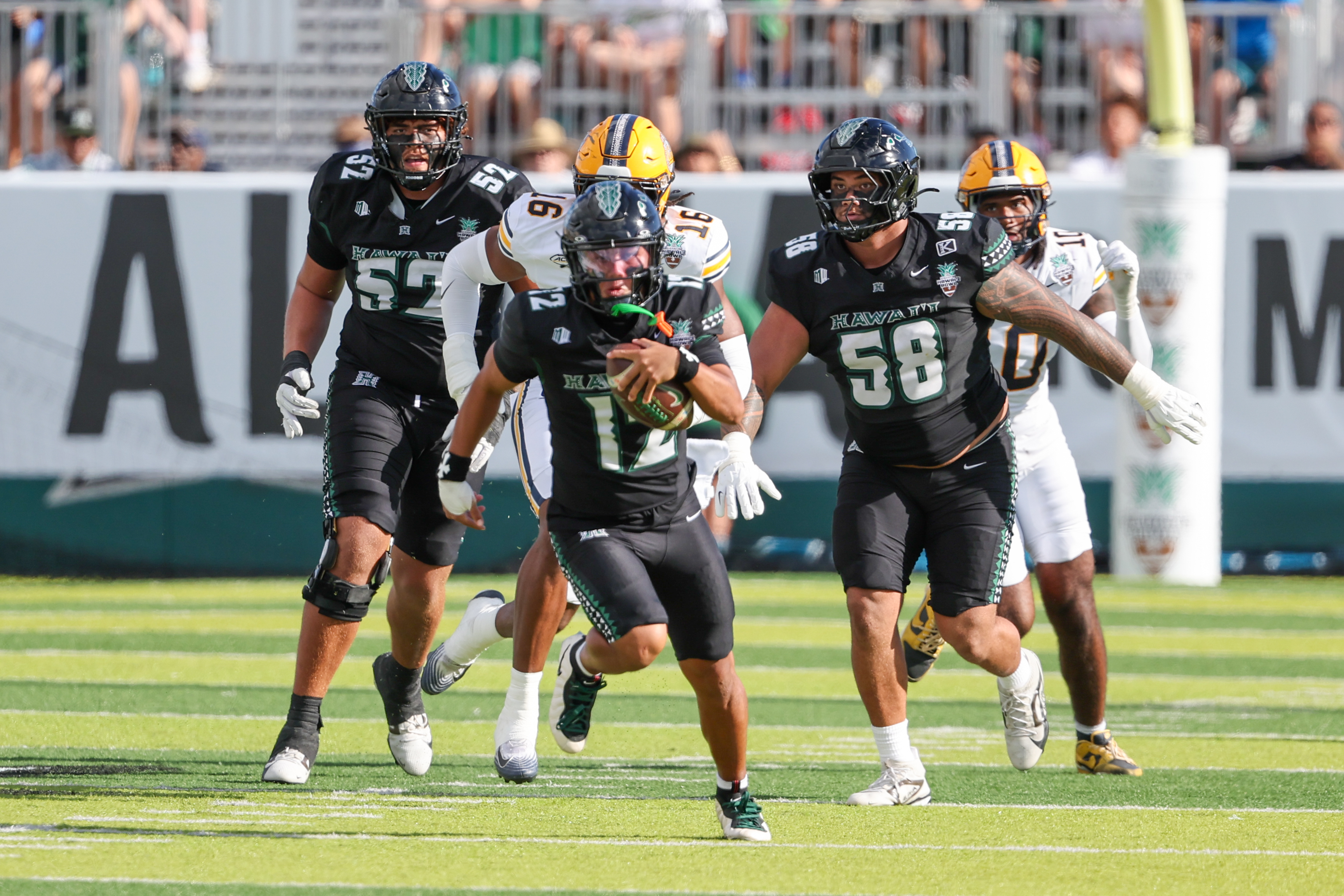 HONOLULU, HAWAII - DECEMBER 24: Micah Alejado #12 of the Hawaii Rainbow Warriors runs the ball during the first half of the Sheraton Hawai'i Bowl against the California Golden Bears at the Clarence T.C. Ching Athletics Complex on December 24, 2025 in Honolulu, Hawaii. (Photo by Darryl Oumi/Getty Images)