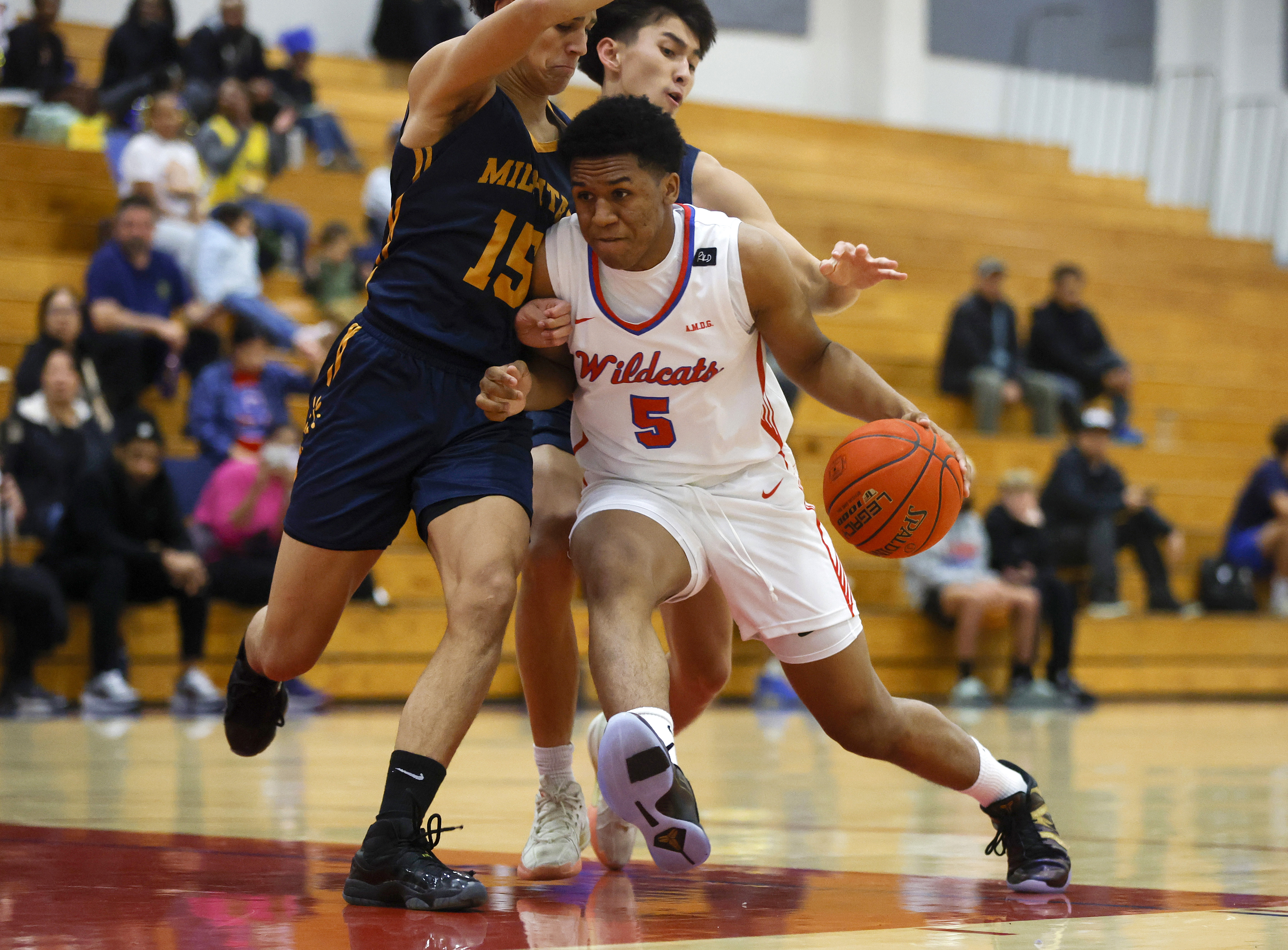 St. Ignatius' Raymond Whitley (5) dribbles against Milpitas' Lamont Davis (15) in the first quarter at St. Ignatius in San Francisco, Calif., on Monday, Feb. 24, 2025. (Nhat V. Meyer/Bay Area News Group)