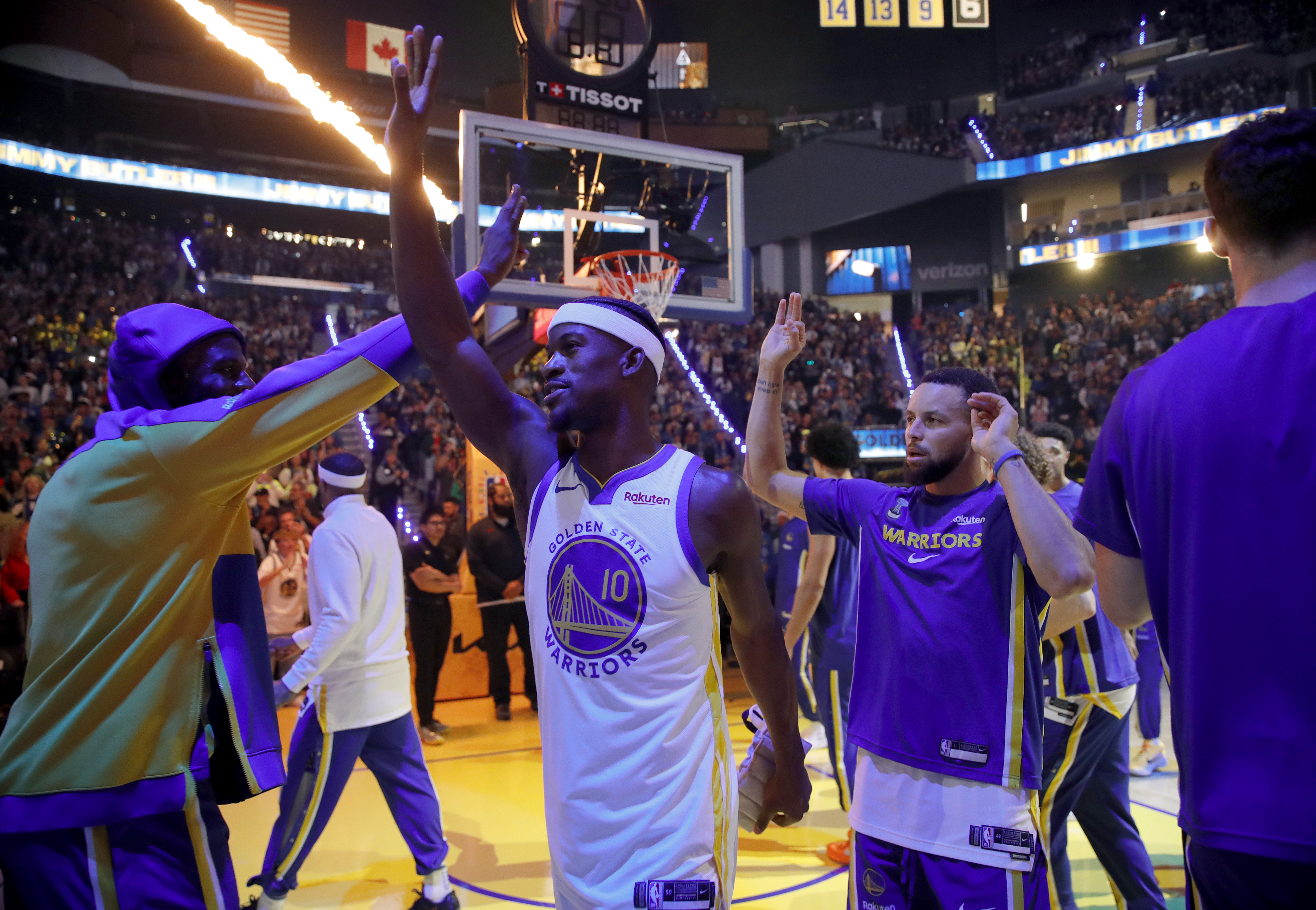 Golden State Warriors' Draymond Green, #23 Jimmy Butler #10 and Stephen Curry, #30 from left, high five during introductions before their Christmas Day NBA game against the Dallas Mavericks at the Chase Center in San Francisco, Calif., on Thursday, Dec. 25, 2025. (Jane Tyska/Bay Area News Group)
