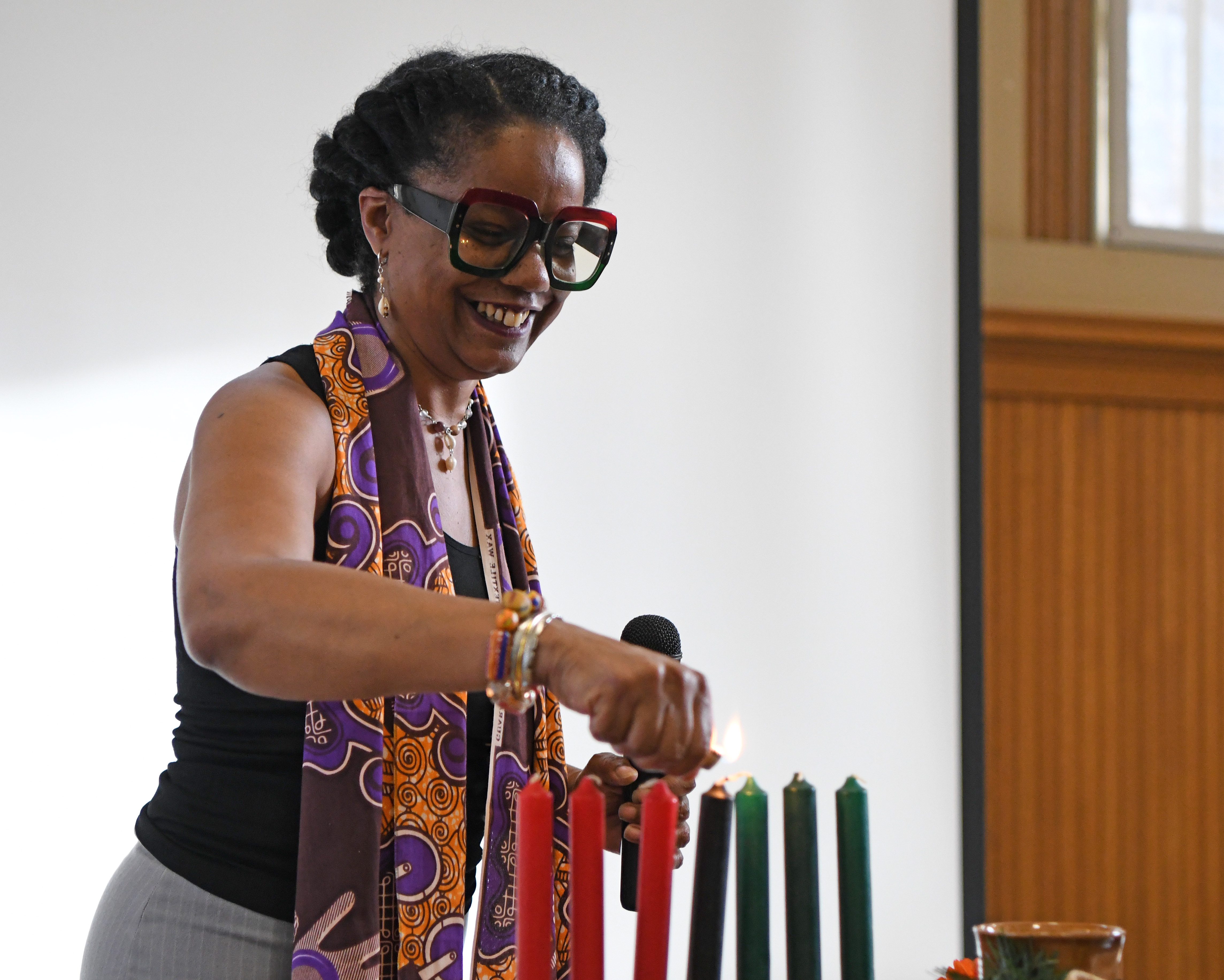 Cultural curator Patanisha Williams prepares to light the first candle of Kwanzaa during a presentation at the African American Museum and Library in Oakland on Dec. 30, 2023. Williams lighted the candles and explains the symbols and principles of Kwanzaa to people in attendance. (Jose Carlos Fajardo/Bay Area News Group)