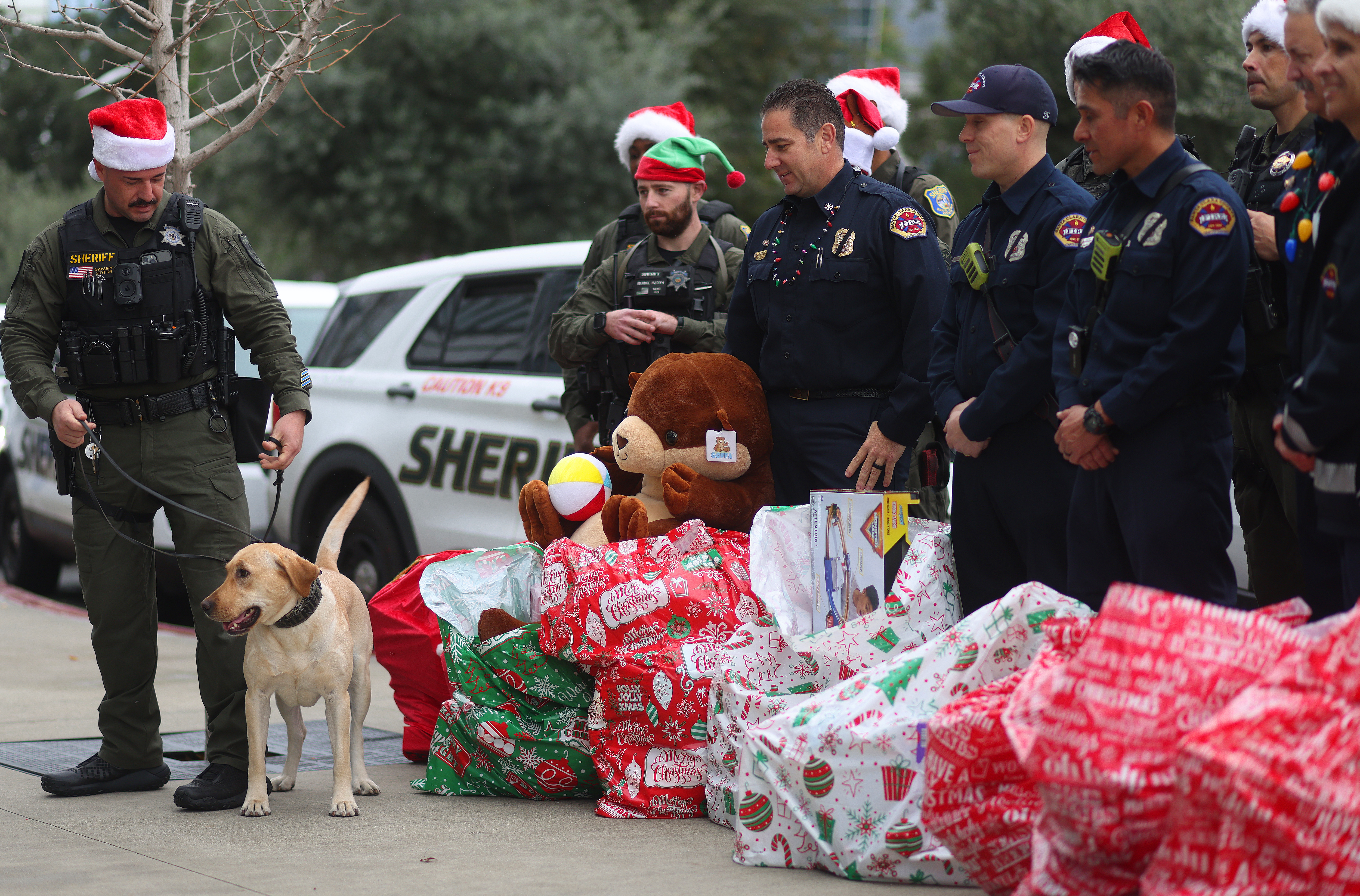 Members of the Santa Clara County Sheriff’s Department and Santa Clara County Fire Department gather bags of toys to deliver in the children’s wing of the Santa Clara Valley Medical Center on Wednesday, Dec. 17, 2025, in San Jose, Calif.  The two departments collected hundreds of toys from the community to be distributed at the hospital and other sites throughout the county.  (Aric Crabb/Bay Area News Group)