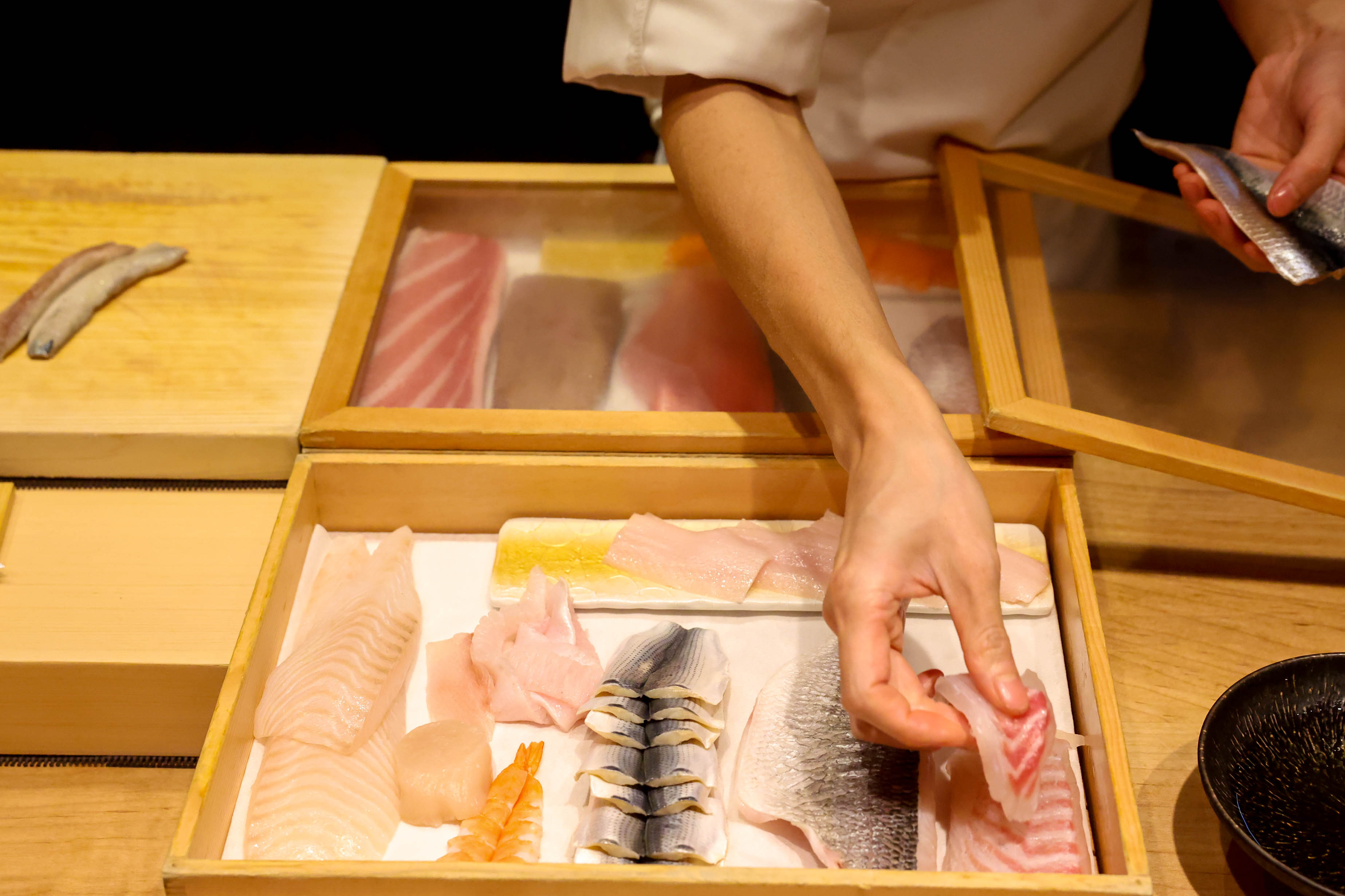 Chef Jeff Chen selects a variety of fish to prepare a dish for customers during an omakase dinner at Tancho Japanese Restaurant in Castro Valley on Dec. 10, 2025. (Ray Chavez/Bay Area News Group)