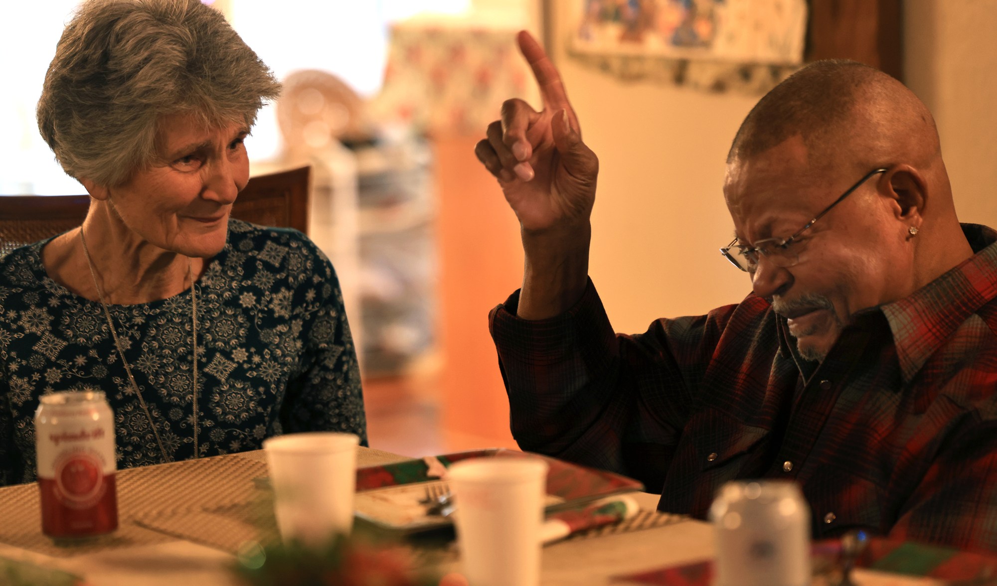 Gail Hines and her husband share a story and give their thanks to God, during a Christmas potluck, Sunday, Dec. 14, 2025. The couple, along with 10 other people, all LaFever Mattson investors gather to share in their heartbreak but also of friendship and fellowship stemming from the ongoing controversy surrounding Lever and Mattson.  (Kent Porter / The Press Democrat)
